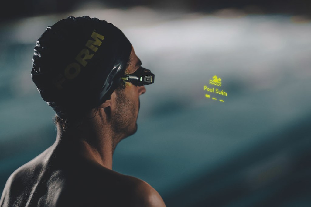 Man looking at Form swim goggles menu