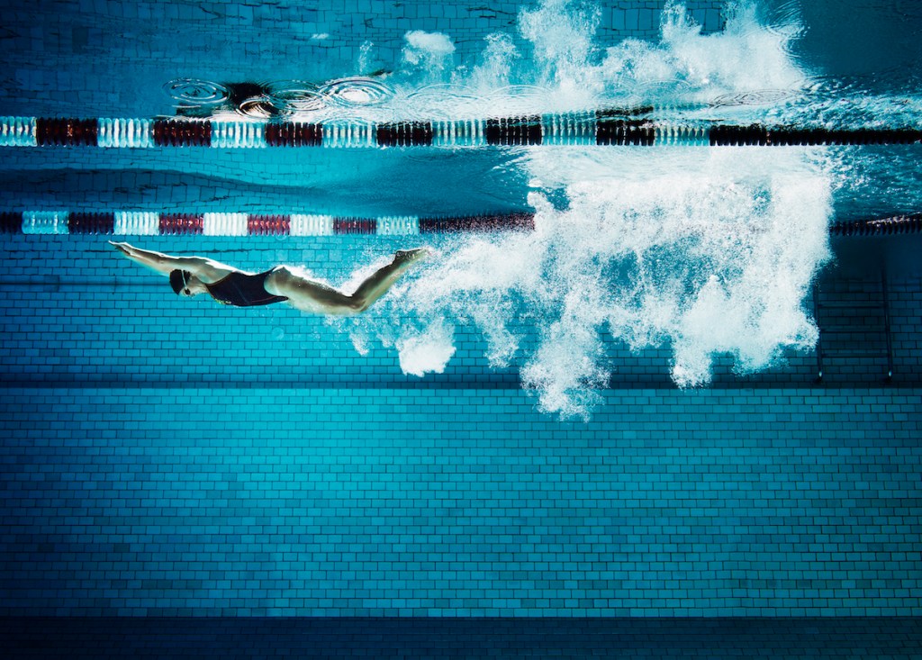 Woman swimming a length of a pool