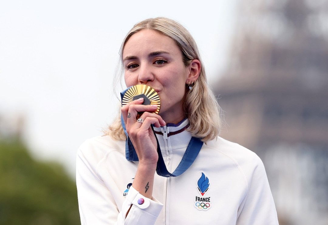 PARIS, FRANCE - JULY 31: Gold medalist Cassandre Beaugrand of Team France celebrates on the podium during the Triathlon medal ceremony after the Women's Individual on Day 5 of the Olympic Games Paris 2024 at Pont Alexandre III on July 31, 2024 in Paris, France