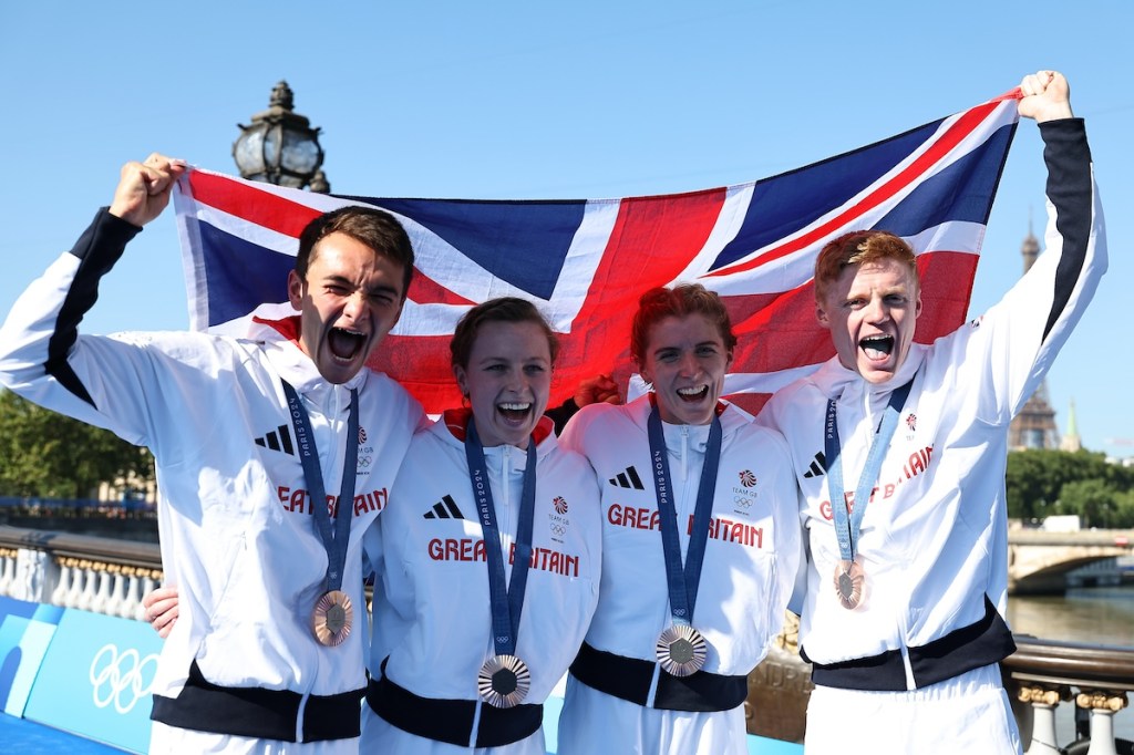 L-R: Mixed team relay bronze medalists Alex Yee, Georgia Taylor-Brown, Beth Potter and Samuel Dickinson celebrate at the 2024 Paris Olympic Games