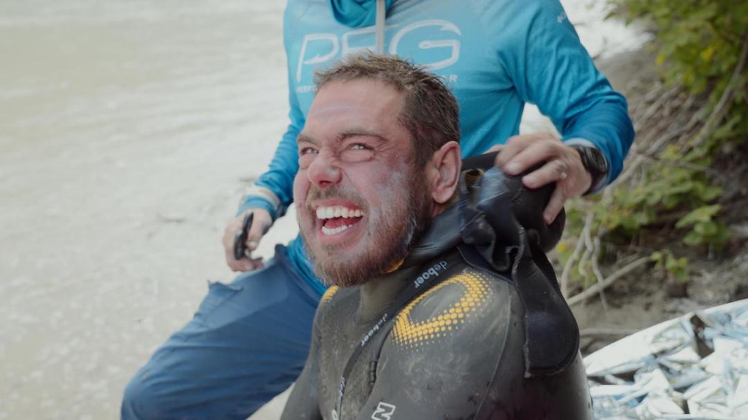 Ross Edgley smiling but battered after completing his world-record continuous swim