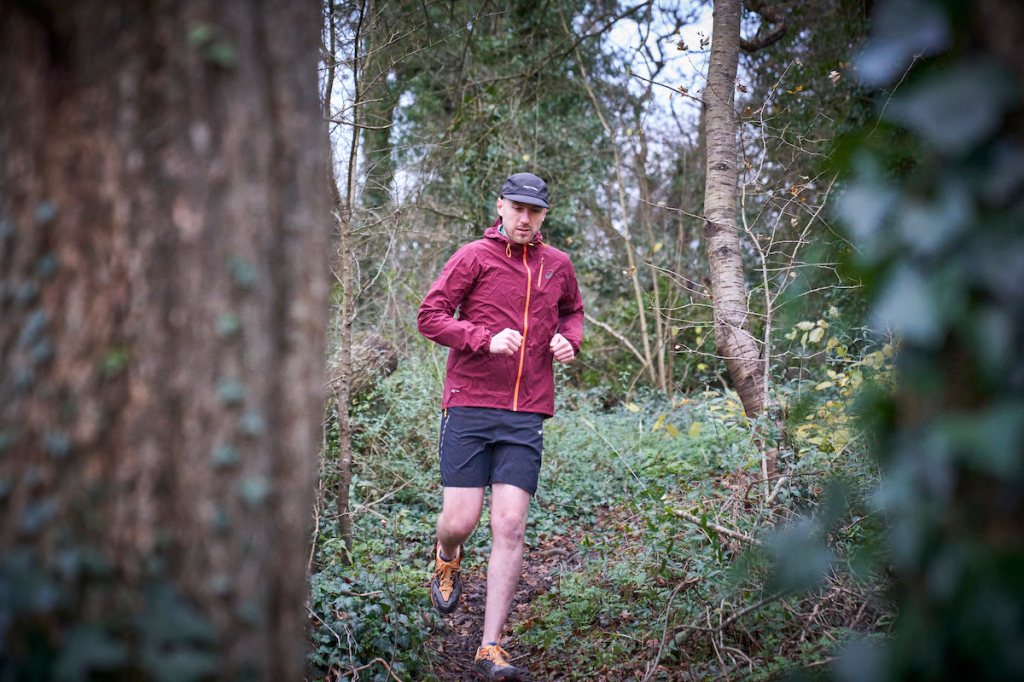 Male runner in the woods on a trail