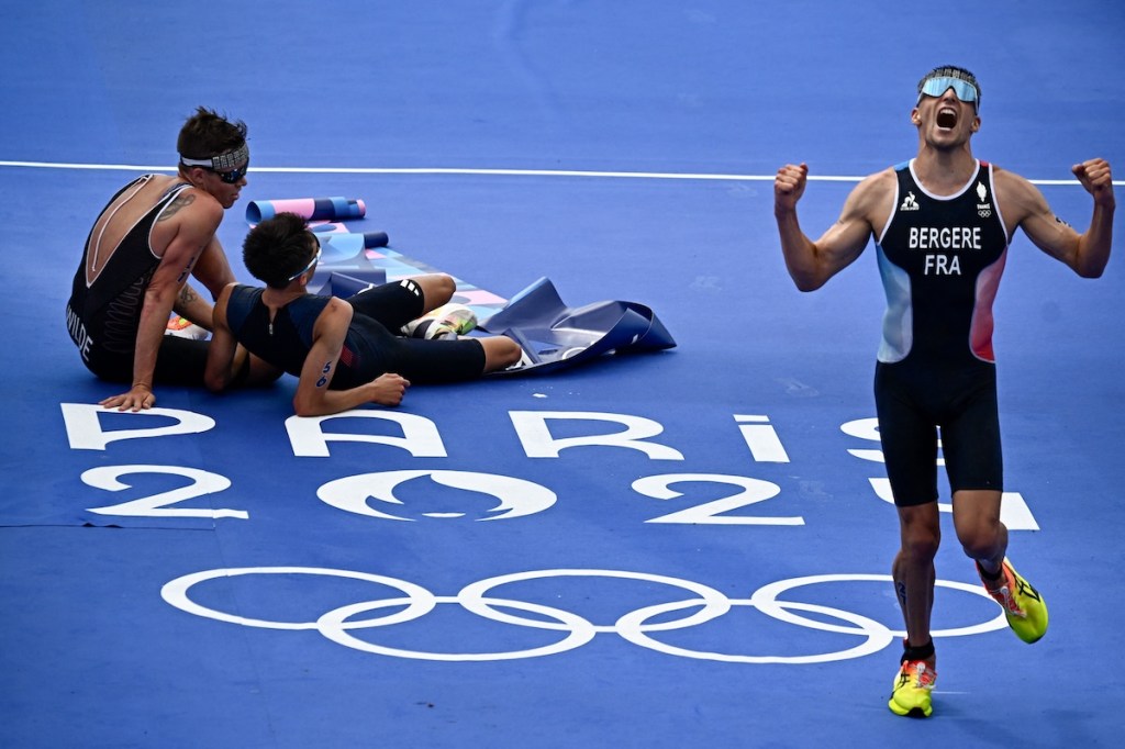 France's Leo Bergere reacts beside Britain's Alex Yee and New Zealand's Hayden Wilde (L) after finishing the men's individual triathlon race at the Paris 2024 Olympic Games in central Paris on July 31, 2024. 