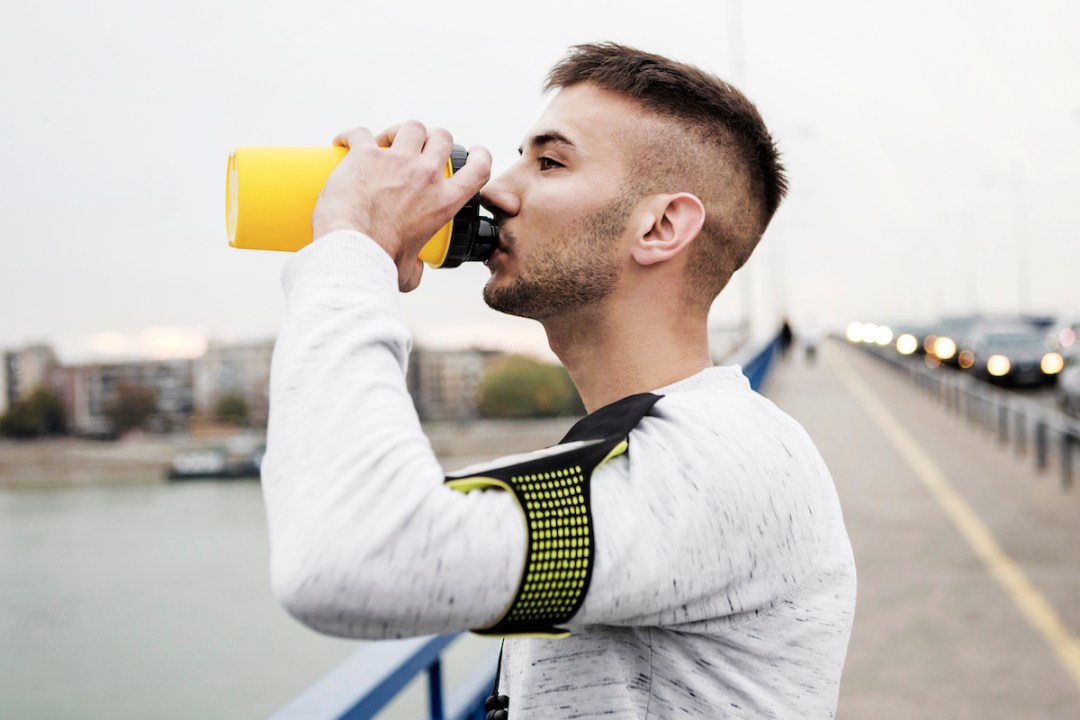 Runner drinking pre-workout