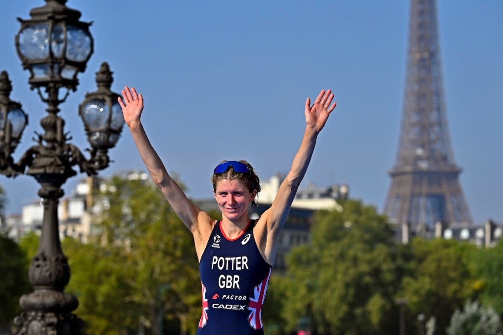 Beth Potter climbs the top step of the podium at the 2023 Paris Olympics triathlon Test Event. 