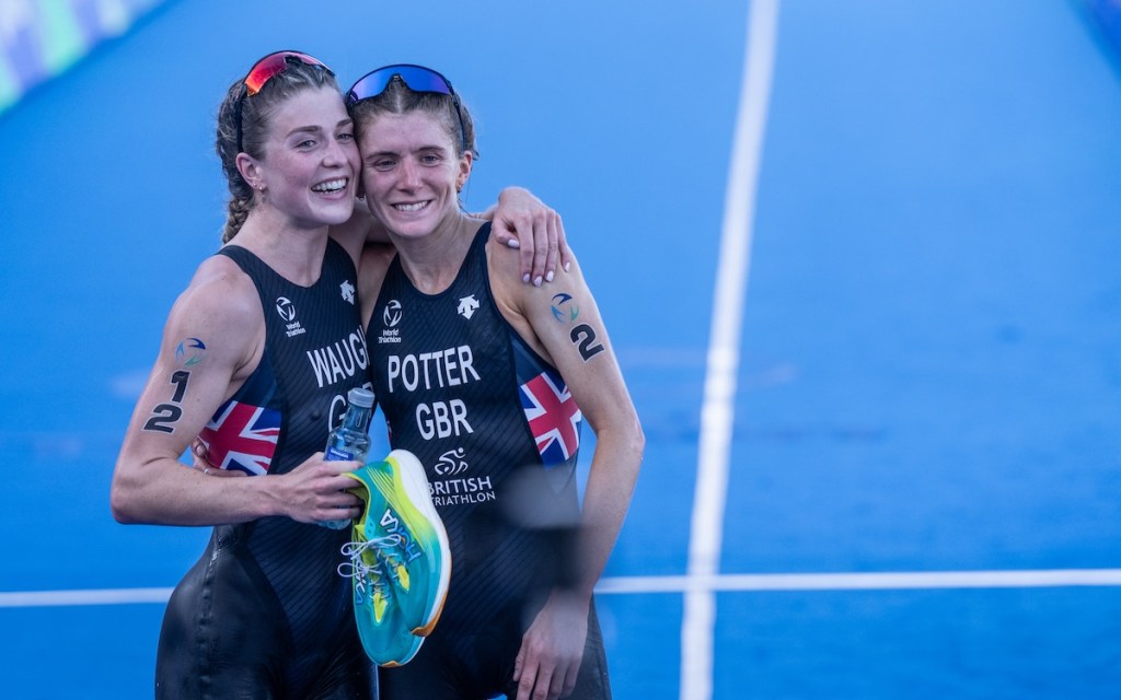 GB triathletes Kate Waugh and Beth Potter celebrate finishing second and first, respectively, at the 2023 Grand Final in Pontevedra, Spain