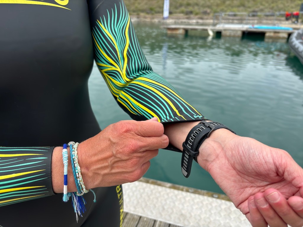 Woman showing flexible wrist on wetsuit