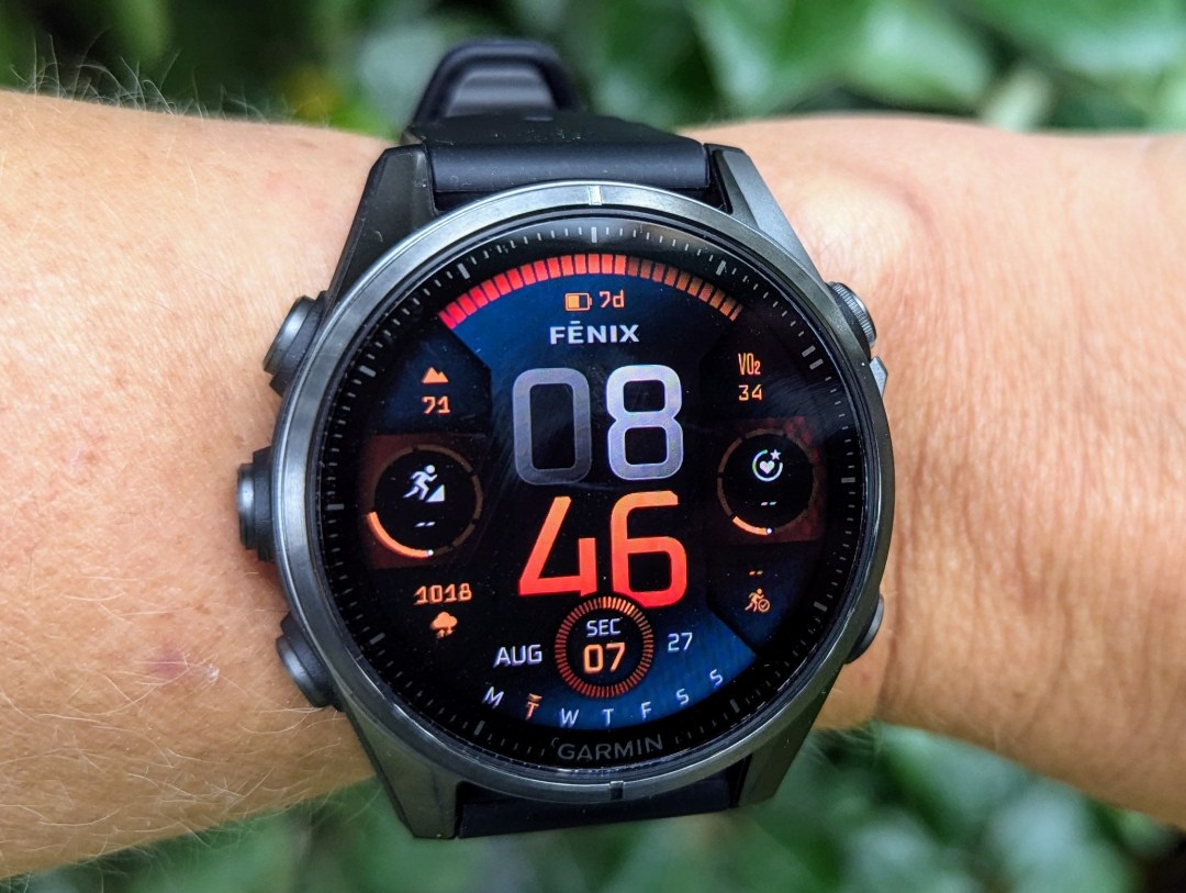 Photo of Garmin Fenix 8 on female tester's wrist, showing home screen