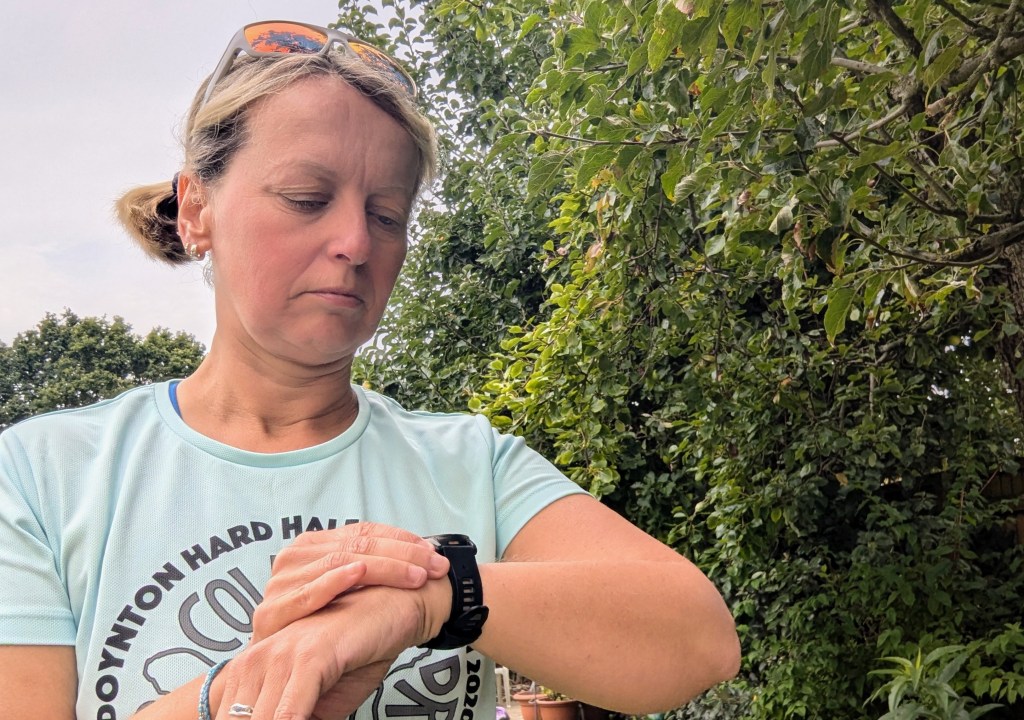 Female runner adjusting button on the new Garmin Fenix 8