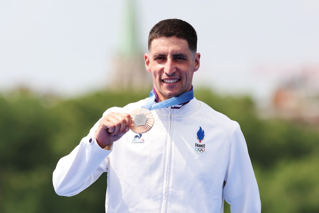 Bronze medalist Leo Bergere of Team France (R) celebrates on the podium during the Triathlon medal ceremony after the Men's Individual on day five of the Olympic Games Paris 2024 at Pont Alexandre III on July 31, 2024 in Paris, France.