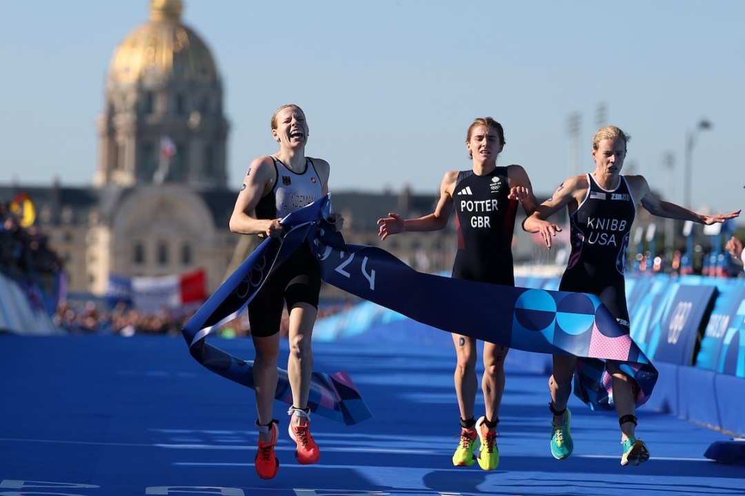 Laura Lindemann of Team Germany crosses the finish line to win the Gold medal ahead of Beth Potter of Team Great Britain and Taylor Knibb of Team United States during the Mixed Relay on day ten of the Olympic Games Paris 2024 at Pont Alexandre III on August 05, 2024 in Paris, France