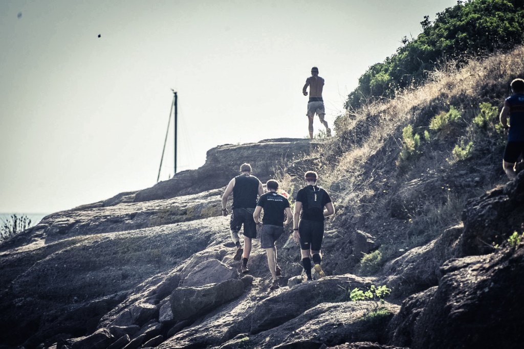 Men running on coastal path