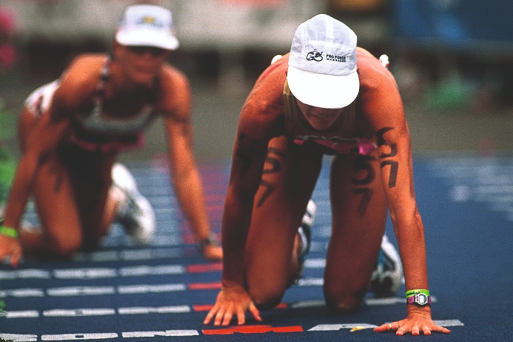 Sian Welch and Wendy Ingraham crawl to the finish line of Kona 1997