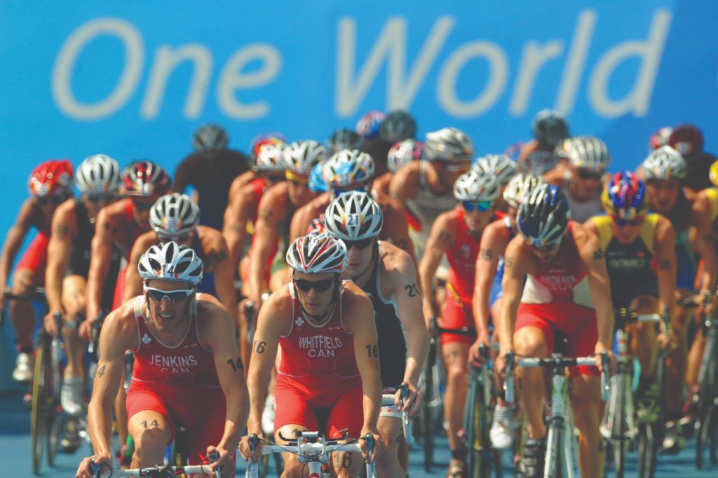 Simon Whitfield is shepherded by his Canadian compatriot Colin Jenkins on the bike at the 2008 Olympics