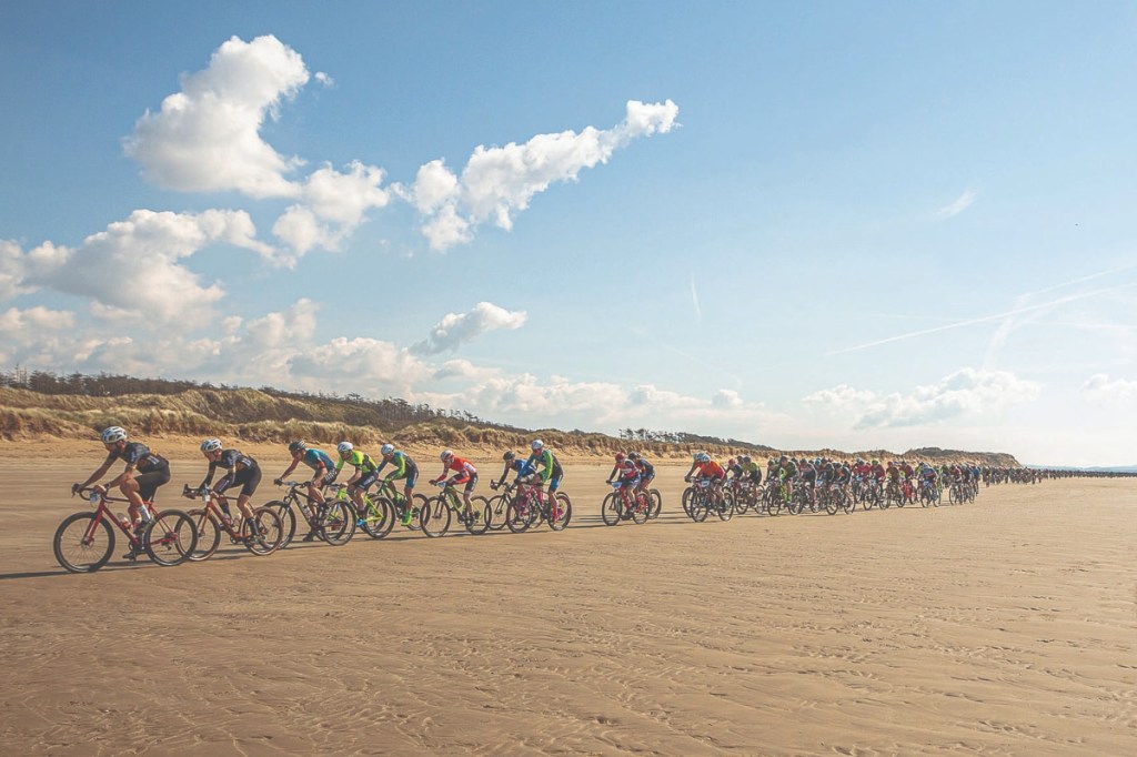 Cyclists riding on beach