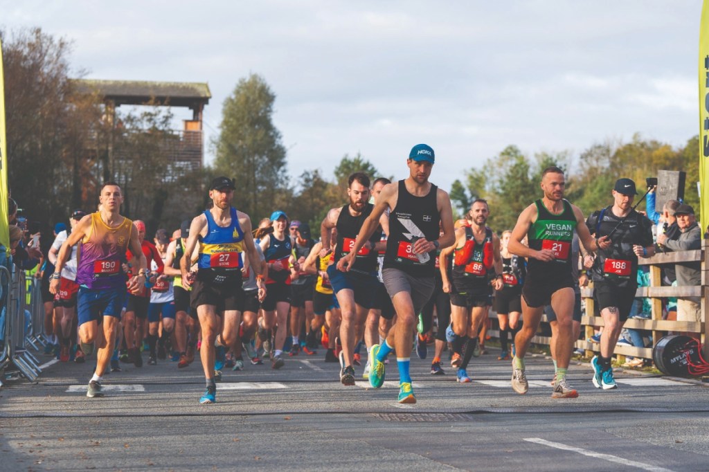 Large group of runners racing in a road marathon