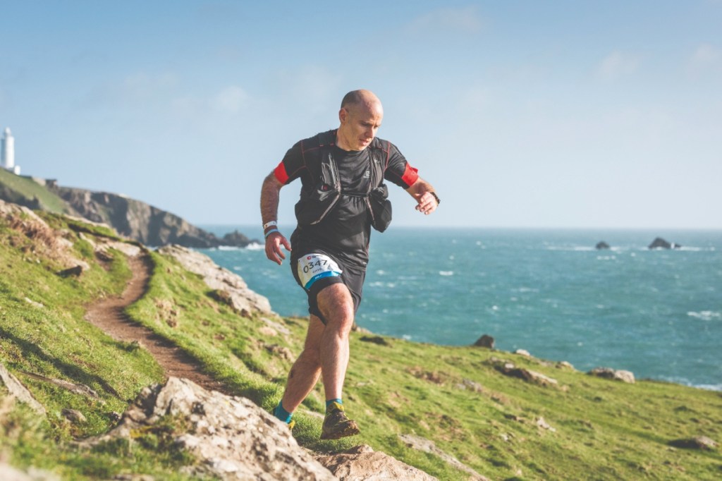 Male runner taking part in a coastal trail race