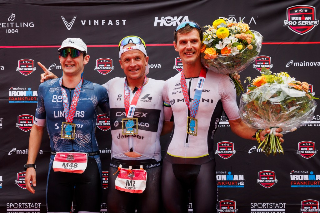 Kieran Lindars (left) celebrates his second place finish in Ironman Frankfurt alongside race winner Kristian Blummenfelt (Pic credit: Jan Hetfleisch/Getty Images for Ironman)