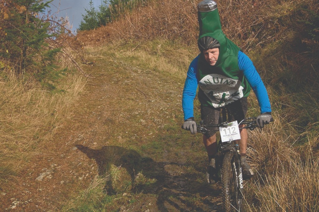 Man on trail bike in beer costume