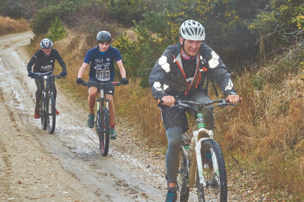 Three male cyclists on trail bikes