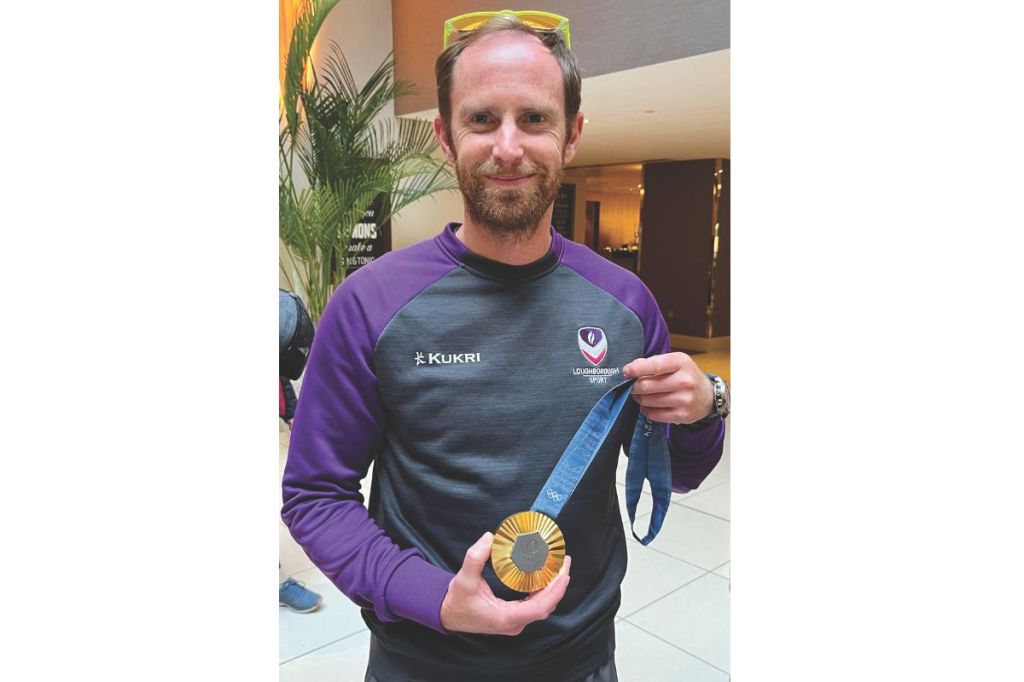 Gavin Smith holding Olympic gold medal