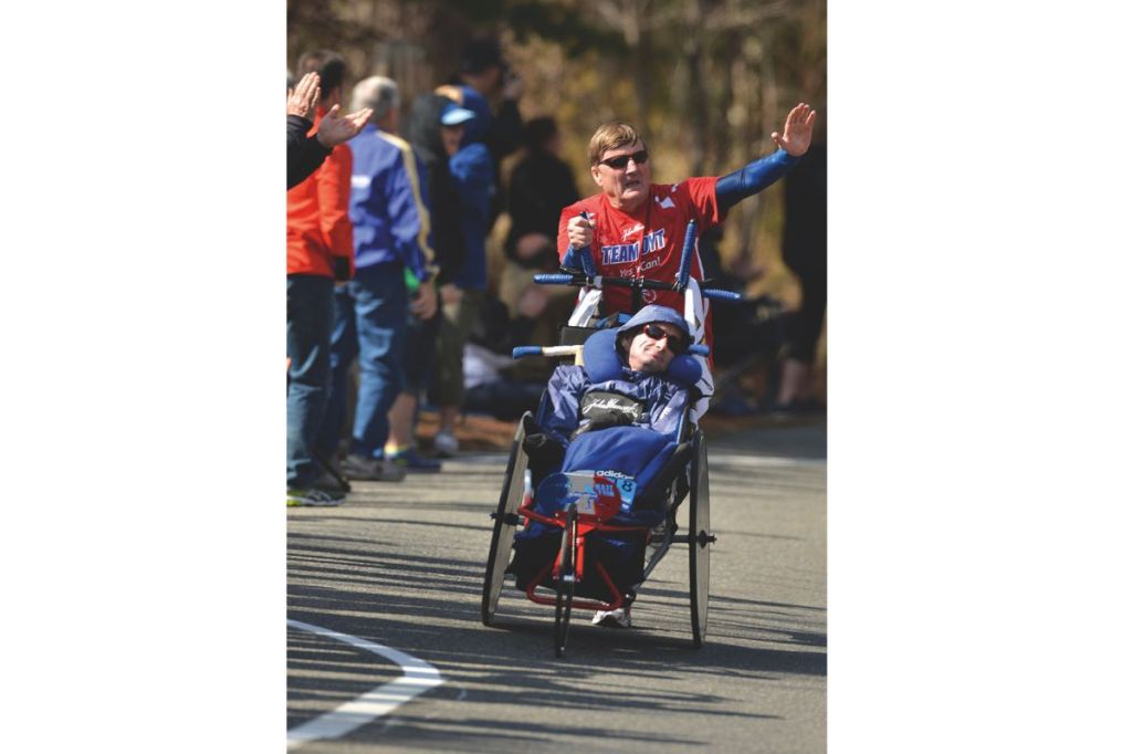 Rick Hoyt propels his disabled son, Dick, on a specially-made bike