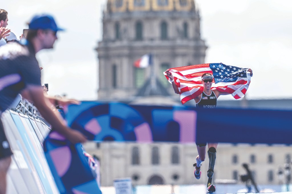 Grace Norman runs with USA flag at Paris 2024