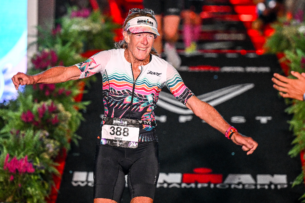 Missy LeStrange smiling as she crosses finish line on foot