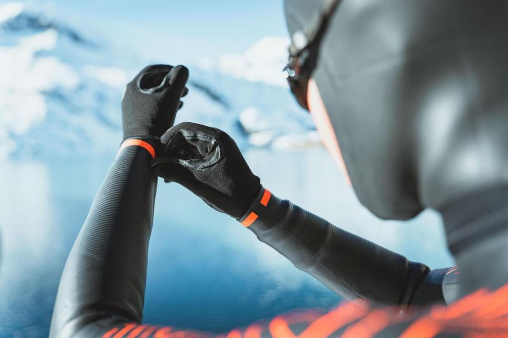 Man adjusting a pair of neoprene swim gloves