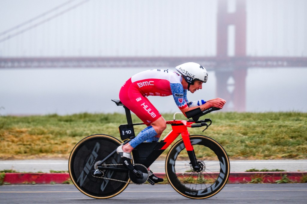 Alistair Brownlee cycling past bridge