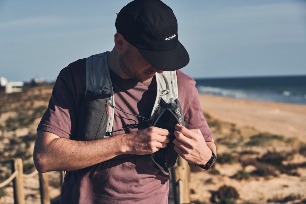 man opening large running vest pocket