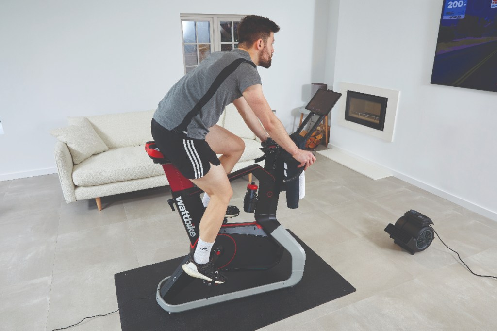 Man riding WattBike as fan blows on to him