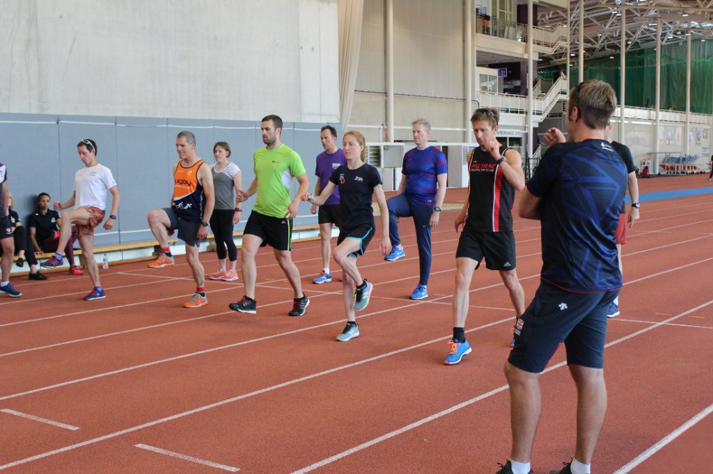 Athletes performing drills on running track