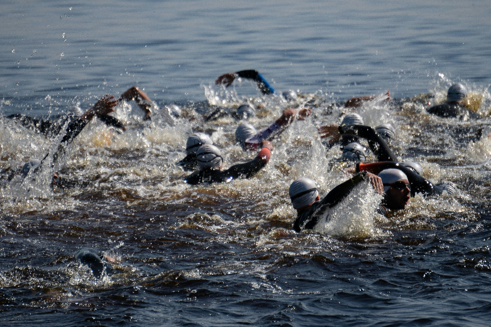 Group of triathletes swimming in open water