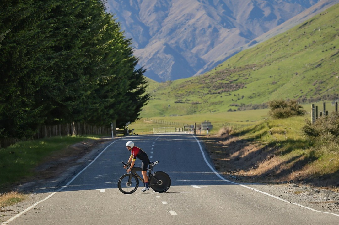 man on triathlon bike in middle of the road